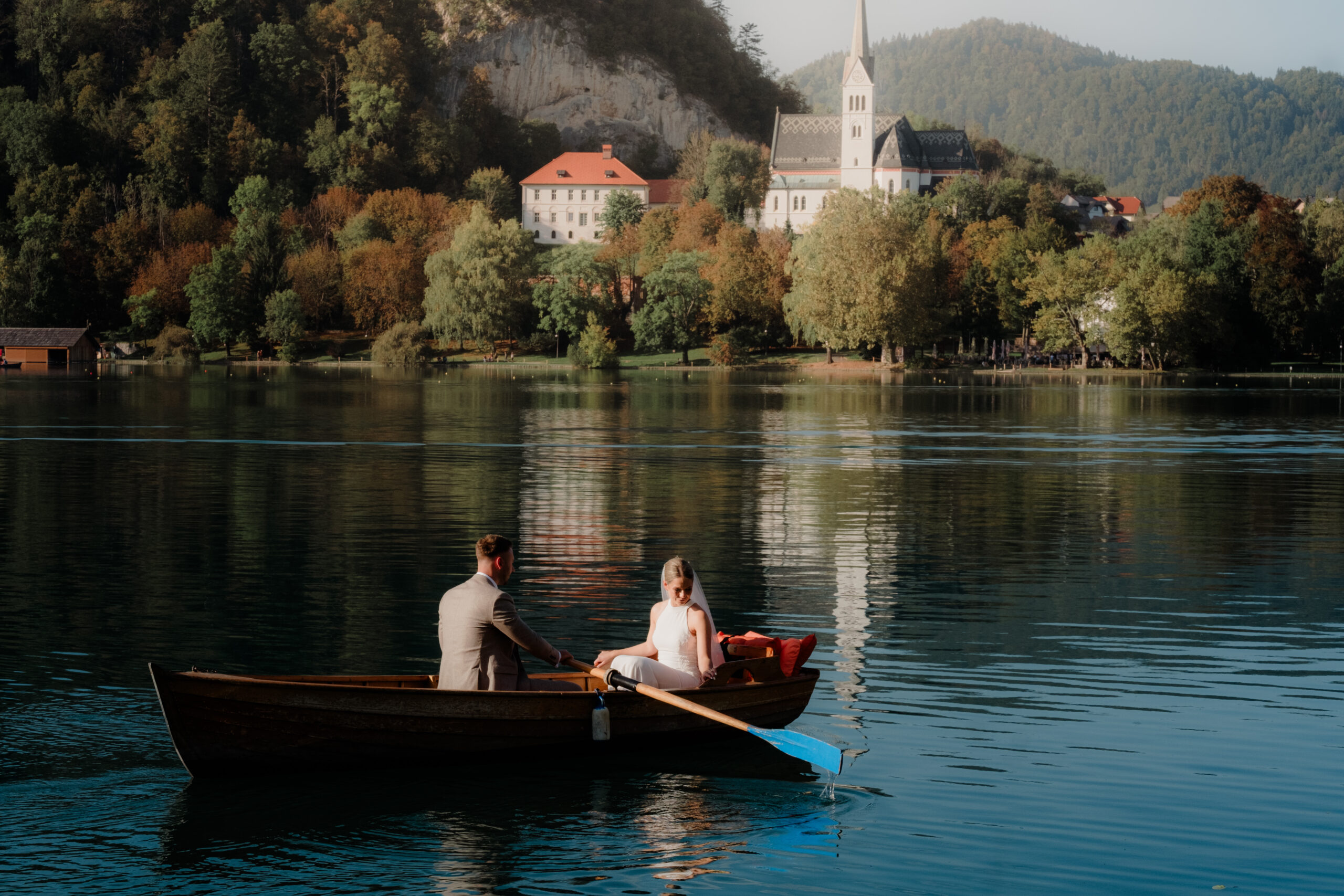 Bride and Groom share a trip in a fishing boat on Lake Bled